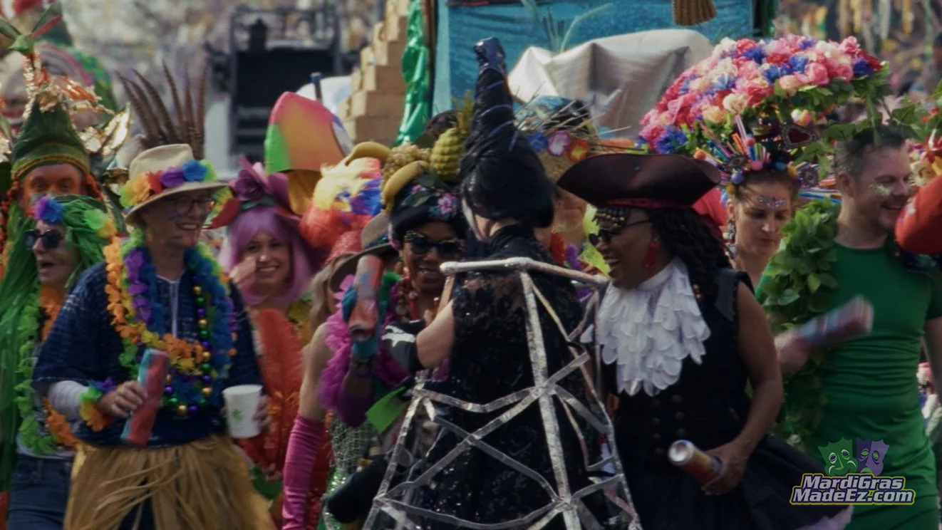 Costumed musicians playing drums in a crowded street